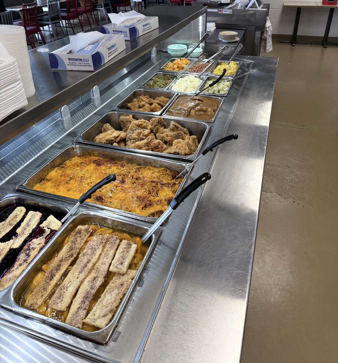 Judy's Restaurant cafeteria line — fried chicken, baked spaghetti, sides, and peach cobbler